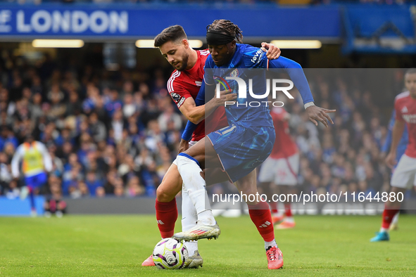 Alex Moreno of Nottingham Forest battles with Noni Madueke of Chelsea during the Premier League match between Chelsea and Nottingham Forest...