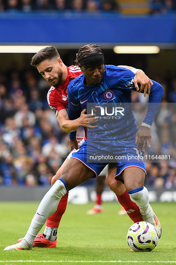 Alex Moreno of Nottingham Forest battles with Noni Madueke of Chelsea during the Premier League match between Chelsea and Nottingham Forest...