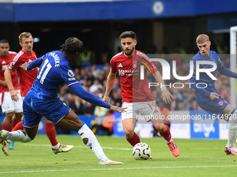 Alex Moreno of Nottingham Forest is under pressure from Noni Madueke of Chelsea during the Premier League match between Chelsea and Nottingh...