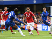 Alex Moreno of Nottingham Forest is under pressure from Noni Madueke of Chelsea during the Premier League match between Chelsea and Nottingh...