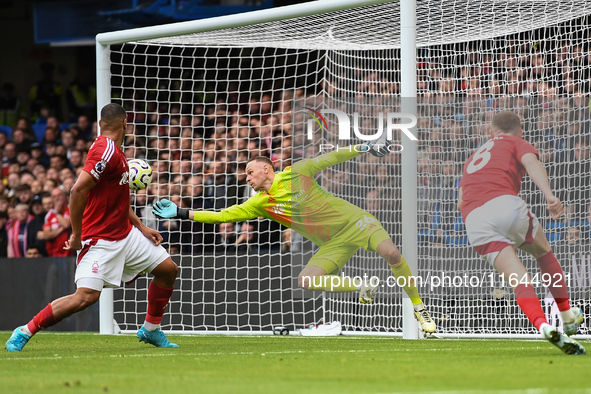 Matz Sels, Nottingham Forest goalkeeper, makes a diving save during the Premier League match between Chelsea and Nottingham Forest at Stamfo...