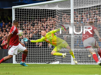 Matz Sels, Nottingham Forest goalkeeper, makes a diving save during the Premier League match between Chelsea and Nottingham Forest at Stamfo...