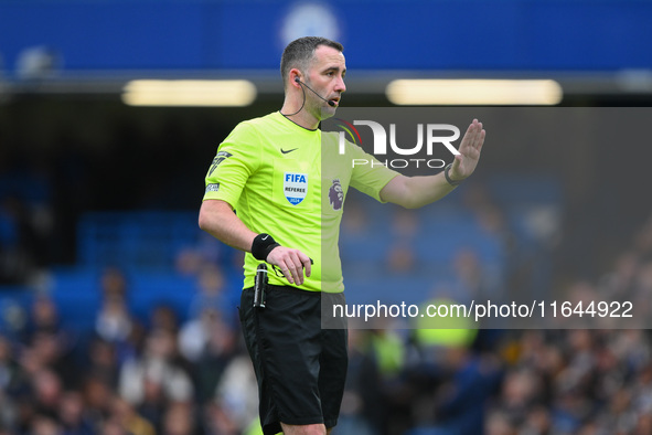 Referee Chris Kavanagh gestures during the Premier League match between Chelsea and Nottingham Forest at Stamford Bridge in London, England,...