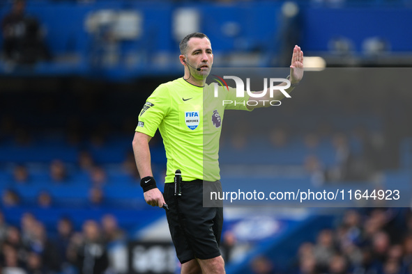 Referee Chris Kavanagh gestures during the Premier League match between Chelsea and Nottingham Forest at Stamford Bridge in London, England,...