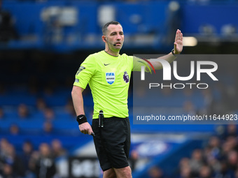 Referee Chris Kavanagh gestures during the Premier League match between Chelsea and Nottingham Forest at Stamford Bridge in London, England,...