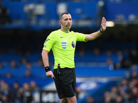 Referee Chris Kavanagh gestures during the Premier League match between Chelsea and Nottingham Forest at Stamford Bridge in London, England,...