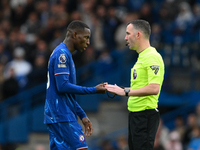 Referee Chris Kavanagh speaks with Nicolas Jackson of Chelsea during the Premier League match between Chelsea and Nottingham Forest at Stamf...