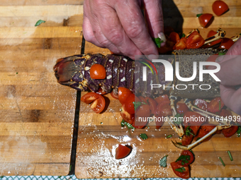 TIRANA, ALBANIA - SEPTEMBER 16:   
A woman prepares a lobster in a local seafood restaurant, seen on September 16, 2024, in Tirana, Albania....