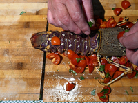 TIRANA, ALBANIA - SEPTEMBER 16:   
A woman prepares a lobster in a local seafood restaurant, seen on September 16, 2024, in Tirana, Albania....