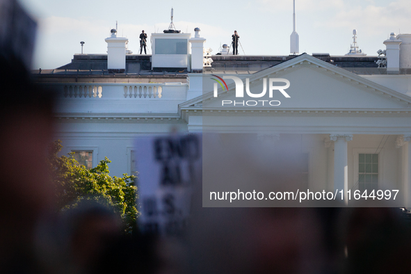 Counter-snipers patrol the White House roof during a demonstration demanding ceasefires in Palestine and Lebanon in Washington, DC, on Octob...