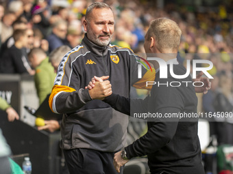 Norwich City Manager, Johannes Hoff Thorup, and Hull City Manager, Tim Walter, shake hands before the Sky Bet Championship match between Nor...