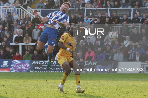 Luke Charman of Hartlepool United challenges for a header with Chinwike Okoli of Sutton United during the Vanarama National League match bet...