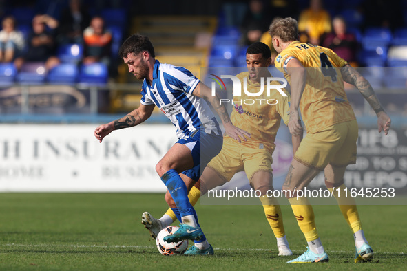 Luke Charman of Hartlepool United battles with Tyler French and Josh Coley of Sutton United during the Vanarama National League match betwee...