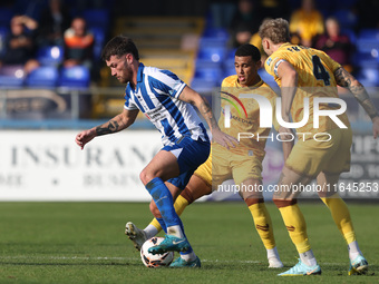 Luke Charman of Hartlepool United battles with Tyler French and Josh Coley of Sutton United during the Vanarama National League match betwee...