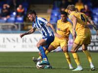 Luke Charman of Hartlepool United battles with Tyler French and Josh Coley of Sutton United during the Vanarama National League match betwee...