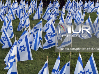 Hundreds of Israeli flags are outside a synagogue as Jews mark the one-year anniversary of the October 7th attack that sparks the Israel-Ham...