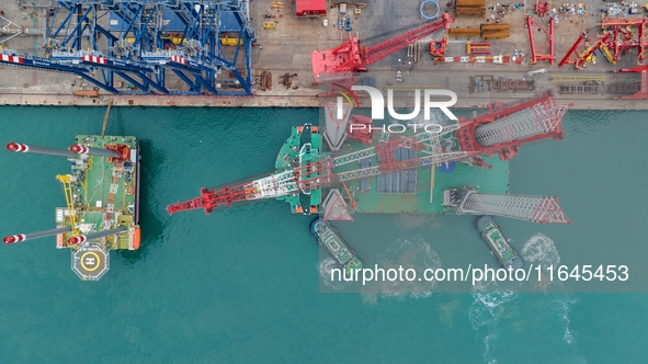 A high-horsepower tugboat pulls the fourth-generation offshore wind power construction platform ''Ganghangping 5'' off the Haixi Heavy Machi...