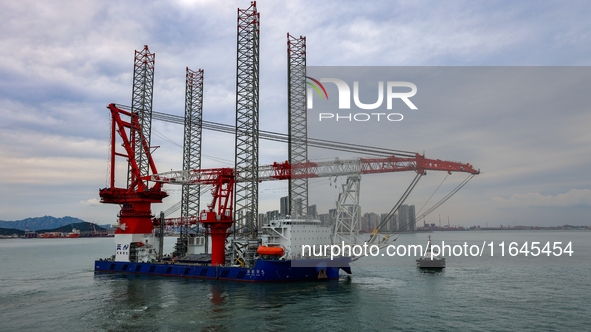 A high-horsepower tugboat pulls the fourth-generation offshore wind power construction platform ''Ganghangping 5'' off the Haixi Heavy Machi...