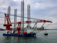 A high-horsepower tugboat pulls the fourth-generation offshore wind power construction platform ''Ganghangping 5'' off the Haixi Heavy Machi...