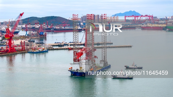 A high-horsepower tugboat pulls the fourth-generation offshore wind power construction platform ''Ganghangping 5'' off the Haixi Heavy Machi...