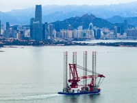 A high-horsepower tugboat pulls the fourth-generation offshore wind power construction platform ''Ganghangping 5'' off the Haixi Heavy Machi...