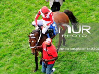 Jockey Sahin Civaci rides Bowman's Run to the winner's circle with trainer Kevin Attard following after the second race at Woodbine Racetrac...