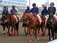 Outriders gather on the track after a race at Woodbine Racetrack in Toronto, Canada, on October 6, 2024. (