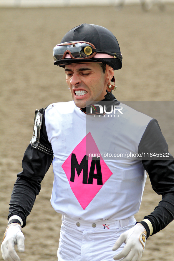 Jockey Leo Salles grimaces following a race at Woodbine Racetrack in Toronto, Canada, on October 6, 2024. 