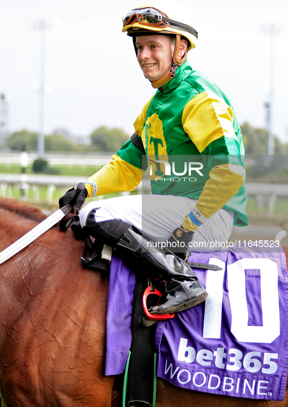 Jockey Austin Adams rides Lady in Red to the winner's circle after a win in the fourth race at Woodbine Racetrack in Toronto, Canada, on Oct...