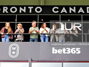 Spectators gather along the grandstand rail to watch a race at Woodbine Racetrack in Toronto, Canada, on October 6, 2024. (