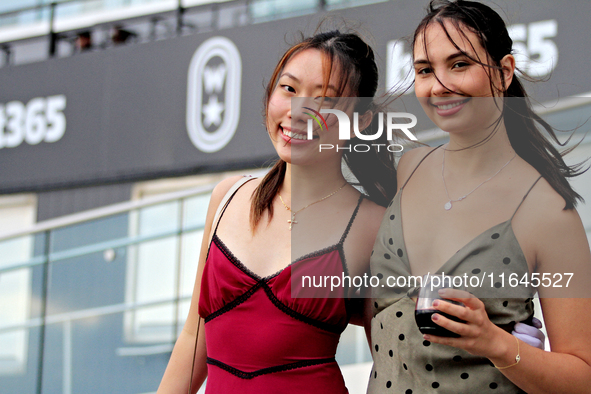 Race fans gather along the apron rail at Woodbine Racetrack in Toronto, Canada, on October 6, 2024. 