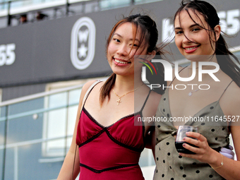 Race fans gather along the apron rail at Woodbine Racetrack in Toronto, Canada, on October 6, 2024. (