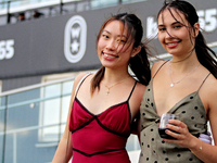 Race fans gather along the apron rail at Woodbine Racetrack in Toronto, Canada, on October 6, 2024. (