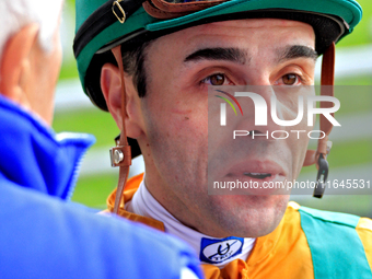 Jockey Leo Salles speaks with connections following the fifth race at Woodbine Racetrack in Toronto, Canada, on October 6, 2024. (