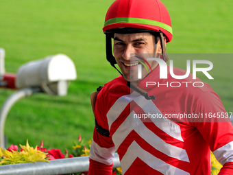 Jockey Sahin Civaci smiles as he leaves the winner's circle after a win in the seventh race at Woodbine Racetrack in Toronto, Canada, on Oct...