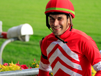 Jockey Sahin Civaci smiles as he leaves the winner's circle after a win in the seventh race at Woodbine Racetrack in Toronto, Canada, on Oct...