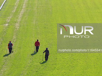 Track employees walk while inspecting and repairing the E.P. Taylor turf course ahead of a race at Woodbine Racetrack in Toronto, Canada, on...