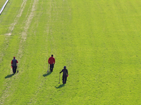 Track employees walk while inspecting and repairing the E.P. Taylor turf course ahead of a race at Woodbine Racetrack in Toronto, Canada, on...