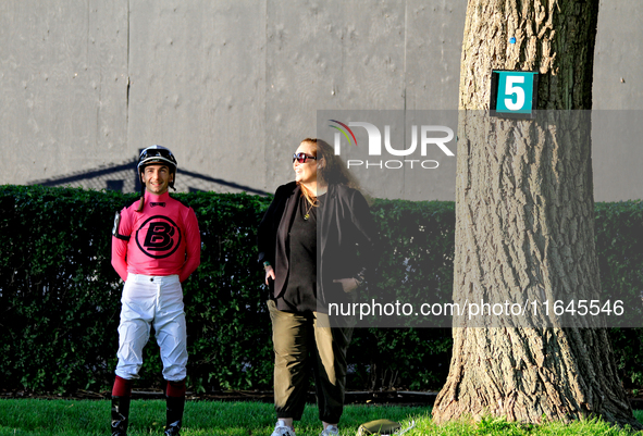 Jockey Vincent Cheminaud stands with connections in the walking ring ahead of the 87th running of the $250,000 Cup & Saucer Stakes race at W...