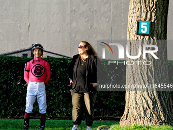 Jockey Vincent Cheminaud stands with connections in the walking ring ahead of the 87th running of the $250,000 Cup & Saucer Stakes race at W...