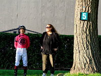 Jockey Vincent Cheminaud stands with connections in the walking ring ahead of the 87th running of the $250,000 Cup & Saucer Stakes race at W...