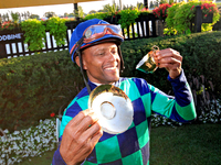 Jockey Patrick Husbands poses for photos after riding Scorching to a win in the 87th running of the $250,000 Cup & Saucer Stakes race at Woo...