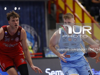 Jayce Johnson of Trieste and Kaspar Treier of Napoli are in action during the Italy Basket Serie A match between Napoli Basket and Pallacane...