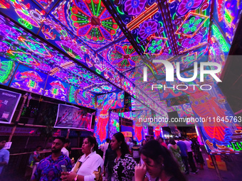 The light illuminates roads during the Durga Puja festival in Kolkata, India, on October 7, 2024. (