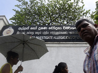 People walk in front of the Commission to Investigate Allegations of Bribery or Corruption office in Colombo, Sri Lanka, on October 4, 2024....