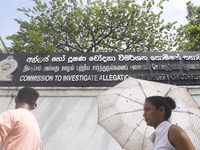 People walk in front of the Commission to Investigate Allegations of Bribery or Corruption office in Colombo, Sri Lanka, on October 4, 2024....