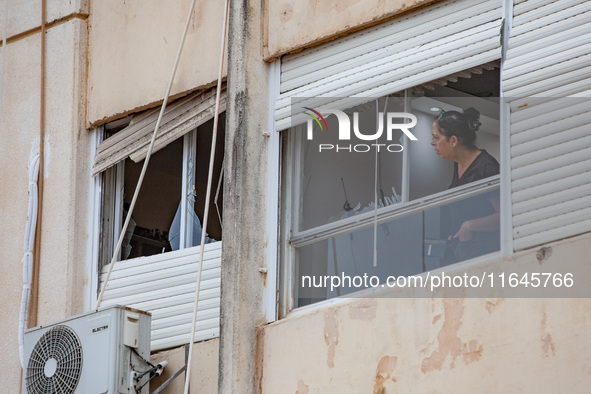 Residents and Israeli authorities inspect the damage following an overnight rocket attack from Lebanon in Haifa, Israel, on October 7, 2024....