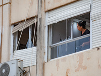 Residents and Israeli authorities inspect the damage following an overnight rocket attack from Lebanon in Haifa, Israel, on October 7, 2024....