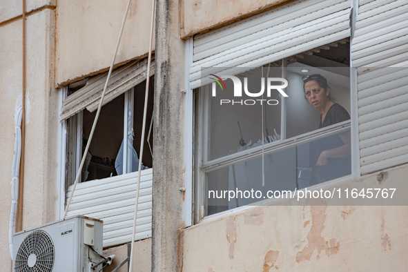 Residents and Israeli authorities inspect the damage following an overnight rocket attack from Lebanon in Haifa, Israel, on October 7, 2024....