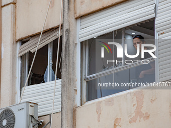 Residents and Israeli authorities inspect the damage following an overnight rocket attack from Lebanon in Haifa, Israel, on October 7, 2024....